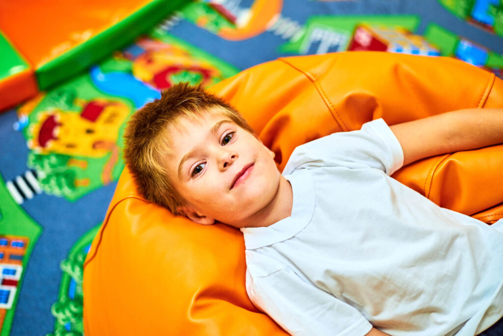 boy laying on a bean bag chair