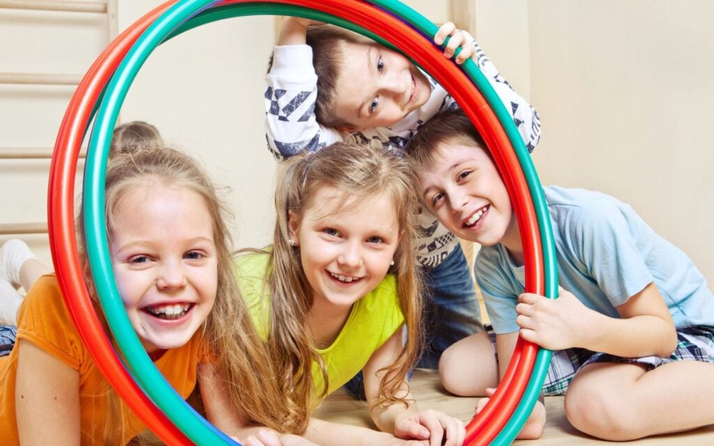 kids smiling in hula hoops