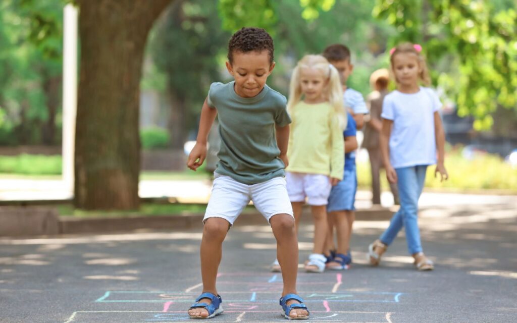 kid playing hopscotch