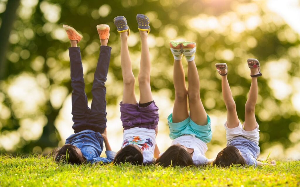kids outside with legs in air